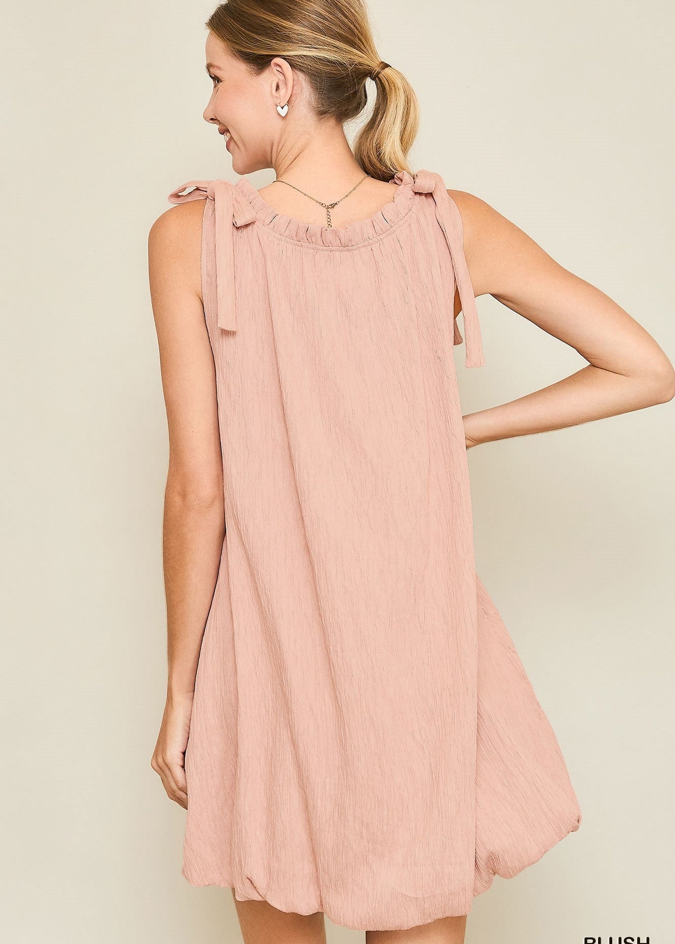 sleeveless mock neck dress with ribbon and ruffles